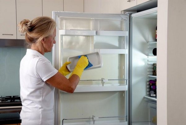  Woman washes a fridge